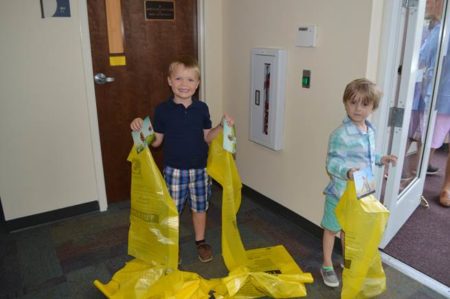 Christ Church children pass out yellow bags to parishioners