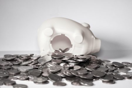 Overturned piggy bank with coins spilling out