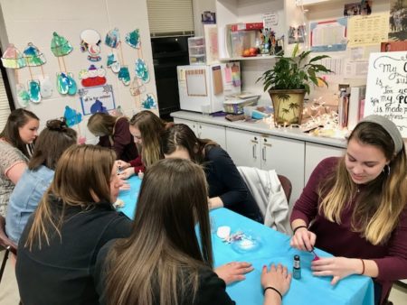 Volunteers paint nails at Party with a Purpose