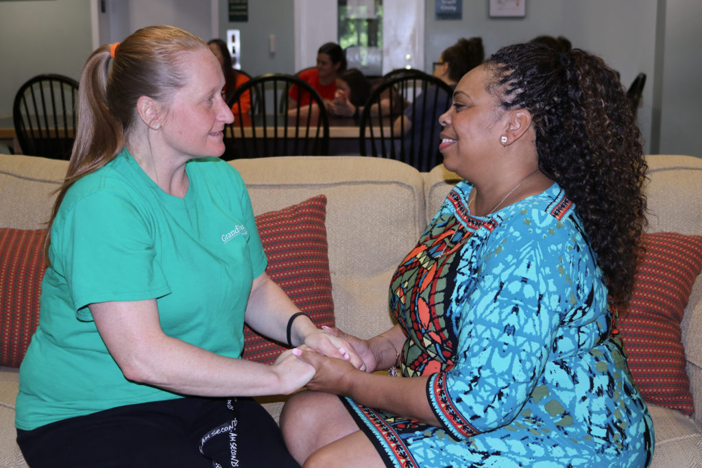 Venus Dixon (right), Director of Renewal, meeting with a woman in recovery